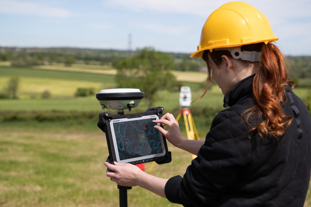 Surveyor using the Panasonic TOUGHBOOK G2 mk3 (4G LTE, EU plug) on a GNSS pole for field mapping and GIS data capture